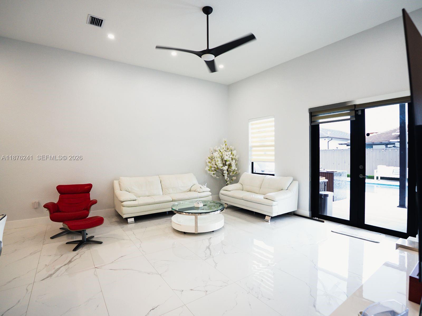14478 Southwest 21st Street Miami, FL 33175 - Photo 31 of 42 a living room with furniture and a window
