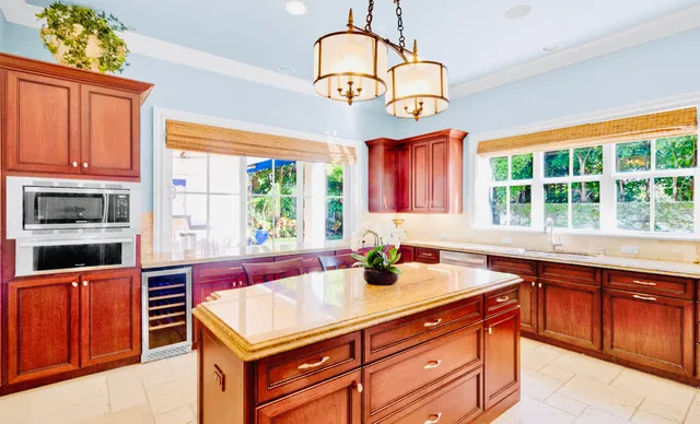 a kitchen with stainless steel appliances granite countertop a stove a sink and a microwave