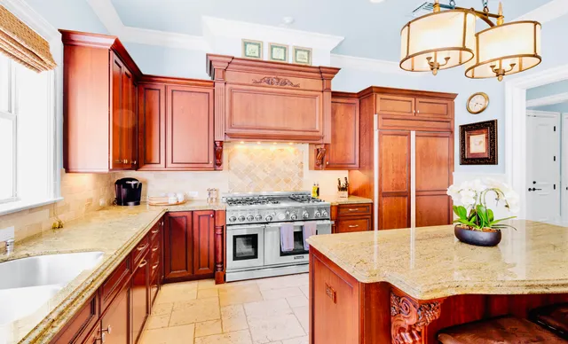 a kitchen with stainless steel appliances granite countertop a stove and a sink