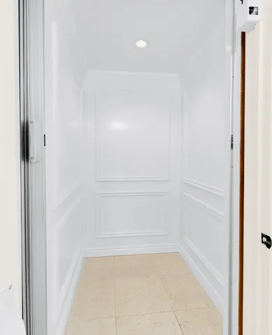 a bedroom with a bed and large windows