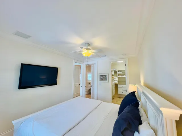 a bathroom with a double vanity sink toilet mirror and shower