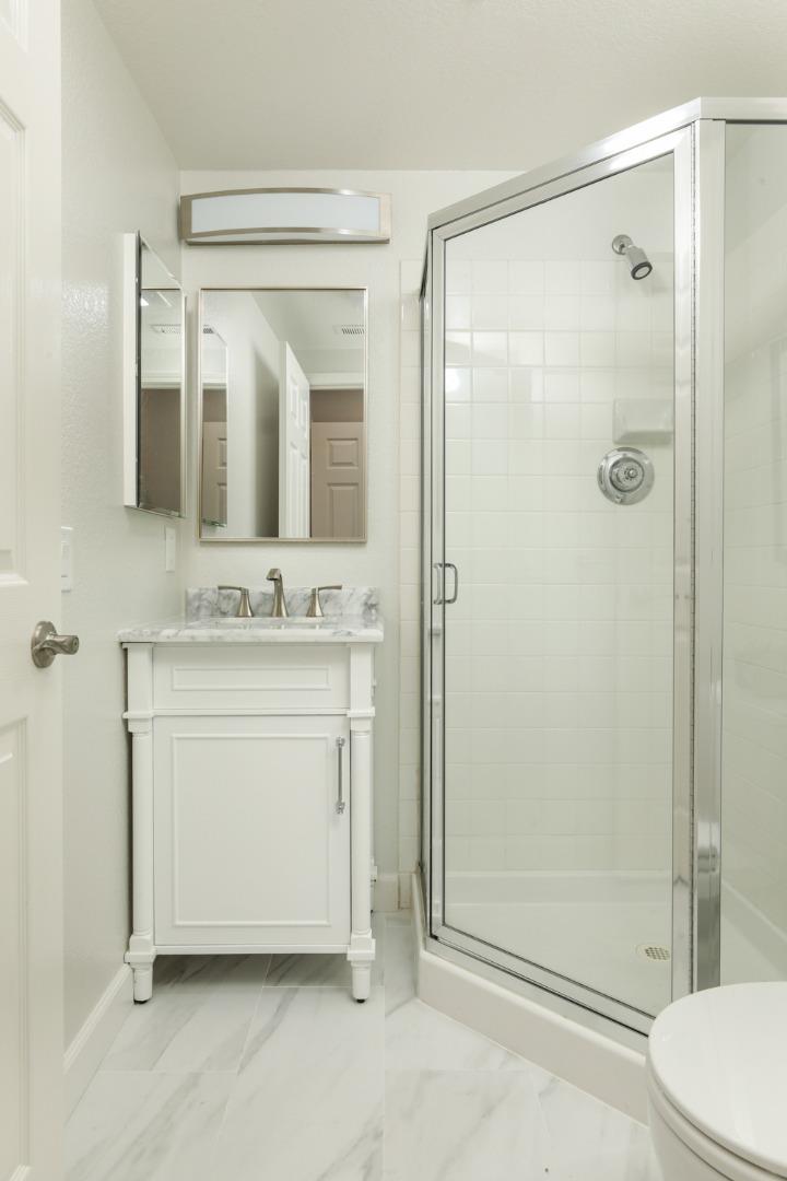 2105 Showers Drive Mountain View, CA 94040 - Photo 18 of 26 a bathroom with a shower sink vanity and mirror