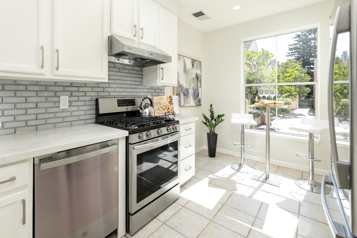 2105 Showers Drive Mountain View, CA 94040 - Photo 6 of 26 a kitchen with a stove a sink and a cabinets