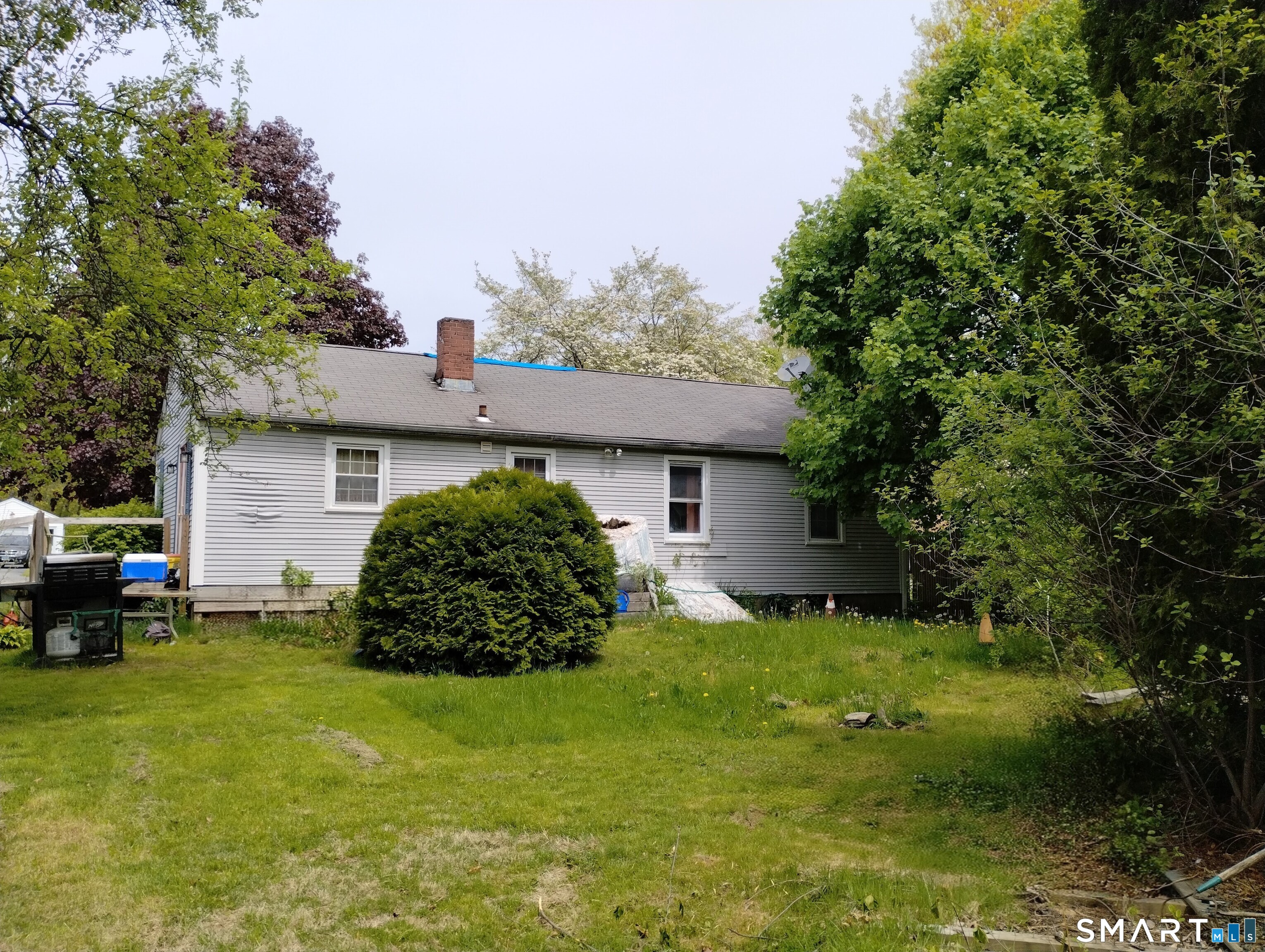 37 Ruth Street Killingly, CT 06239 - Photo 9 of 9 a backyard of a house with table and chairs