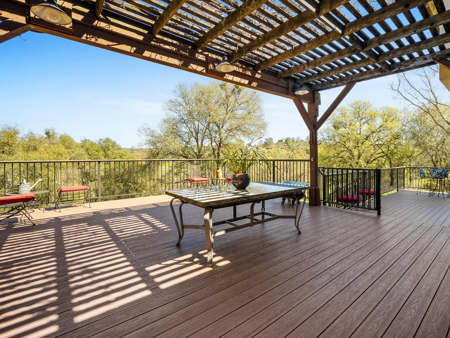 5373 Prairie Loop Placerville, CA 95667 - Photo 27 of 32 Massive entertaining deck with wisteria starting to bloom over the pergola.