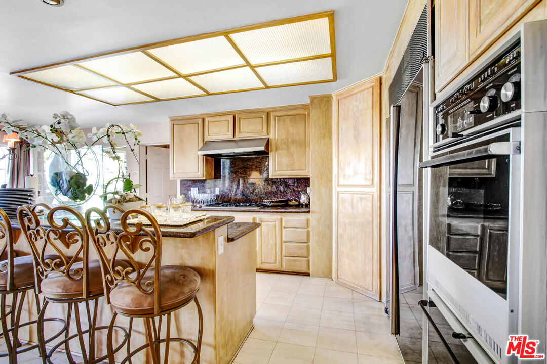 12535 Promontory Road Los Angeles, CA 90049 - Photo 14 of 42 a kitchen with a sink and cabinets