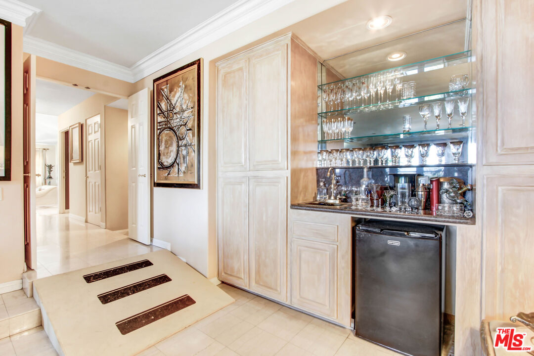12535 Promontory Road Los Angeles, CA 90049 - Photo 15 of 42 a kitchen with stainless steel appliances granite countertop a refrigerator and a sink