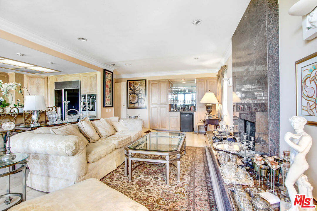 12535 Promontory Road Los Angeles, CA 90049 - Photo 16 of 42 a living room with furniture and a fireplace
