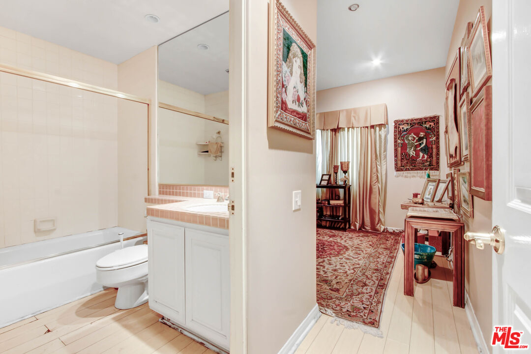12535 Promontory Road Los Angeles, CA 90049 - Photo 19 of 42 a bathroom with a toilet sink and shower