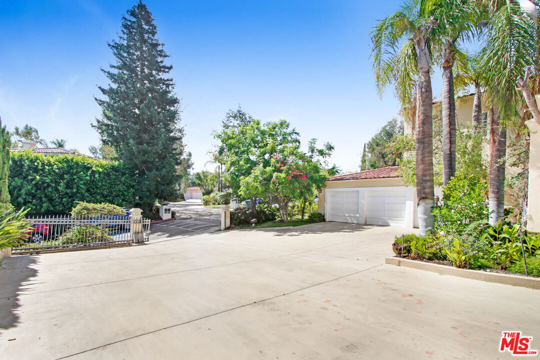 12535 Promontory Road Los Angeles, CA 90049 - Photo 2 of 42 a view of backyard with a garden and entertaining space