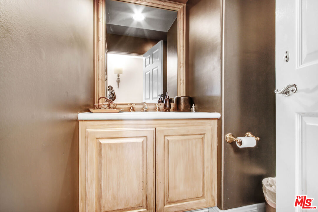 12535 Promontory Road Los Angeles, CA 90049 - Photo 22 of 42 a bathroom with a sink and a mirror