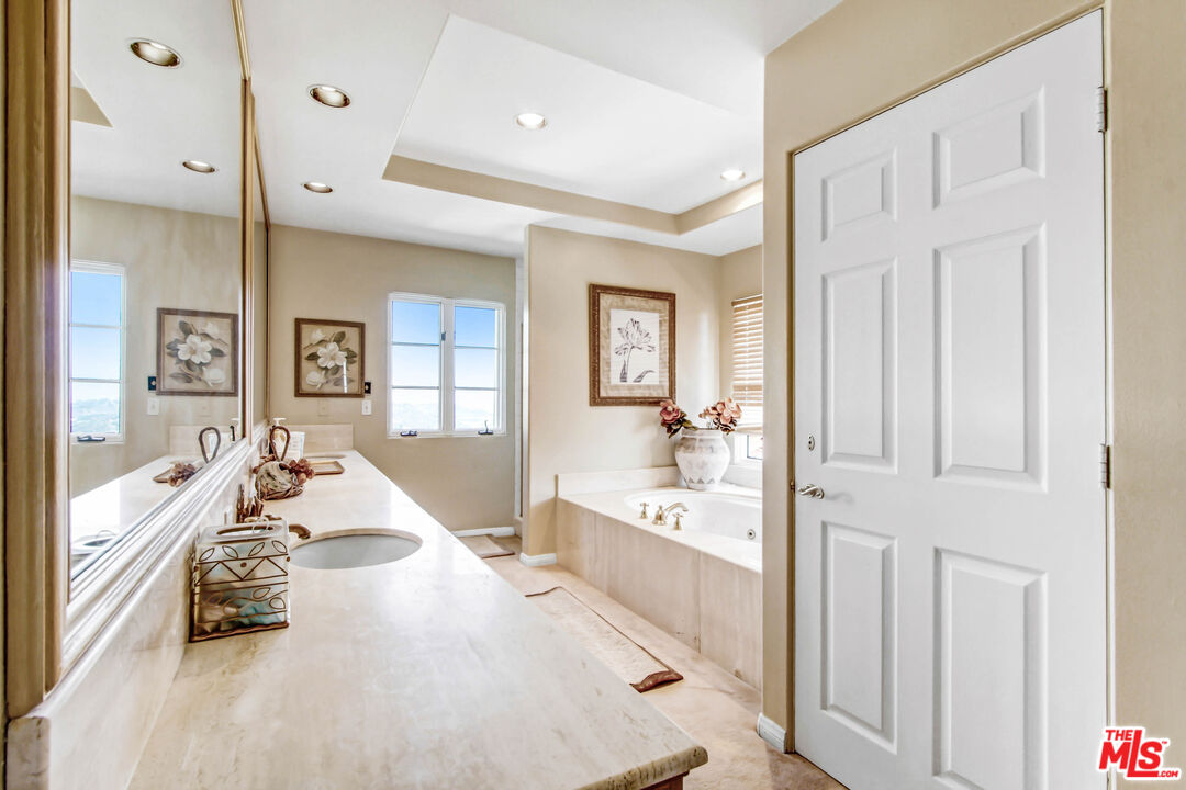 12535 Promontory Road Los Angeles, CA 90049 - Photo 29 of 42 a large white room with a large tub and shower