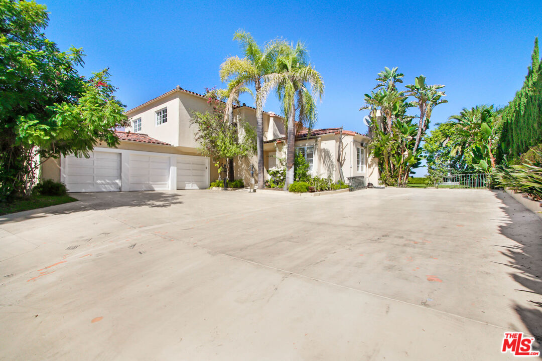 12535 Promontory Road Los Angeles, CA 90049 - Photo 3 of 42 a view of a house with a street