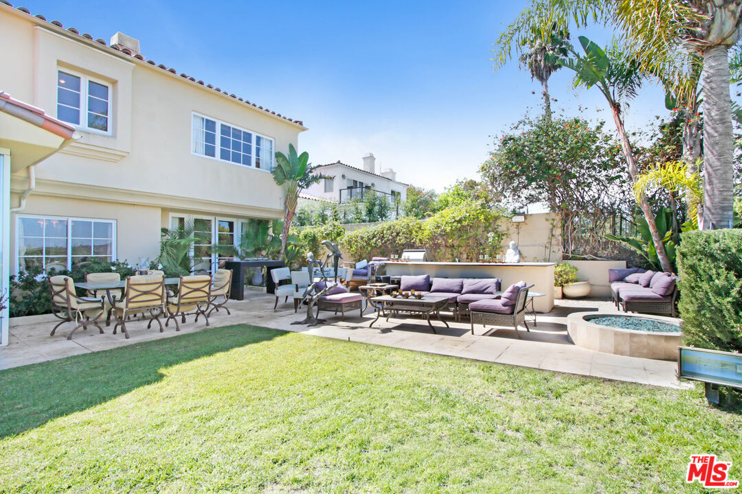 12535 Promontory Road Los Angeles, CA 90049 - Photo 31 of 42 a row of palm trees sitting in front of a house