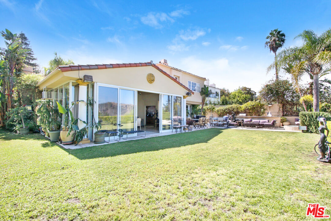 12535 Promontory Road Los Angeles, CA 90049 - Photo 32 of 42 a view of a house with swimming pool and sitting area