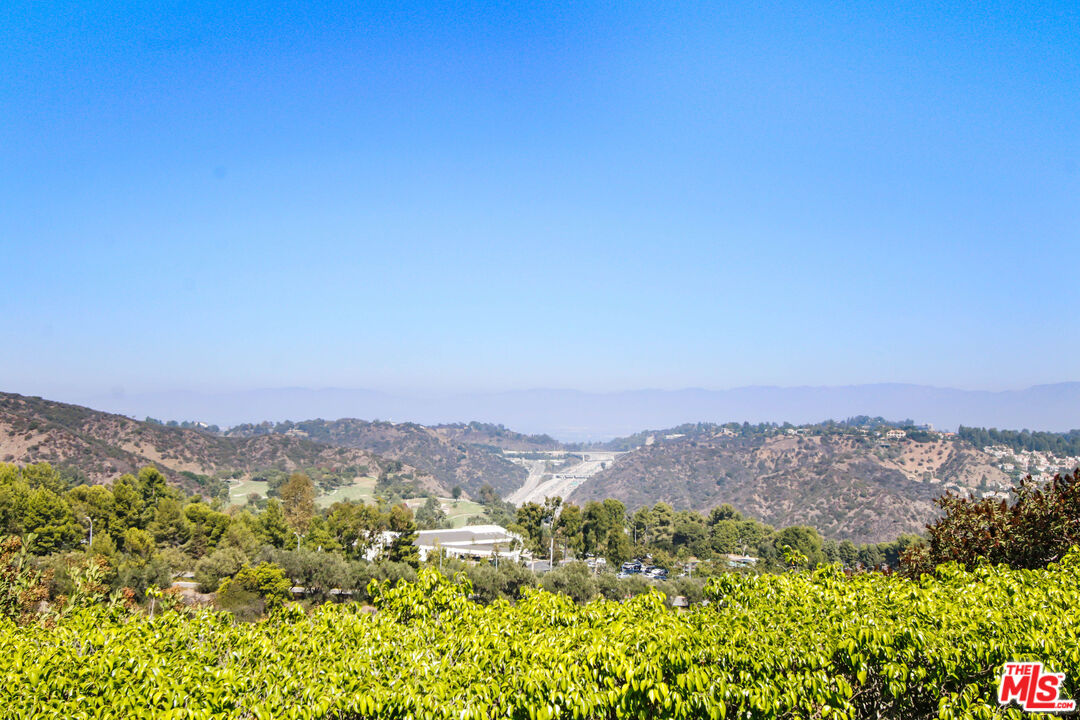 12535 Promontory Road Los Angeles, CA 90049 - Photo 34 of 42 a view of a city with mountains in the background