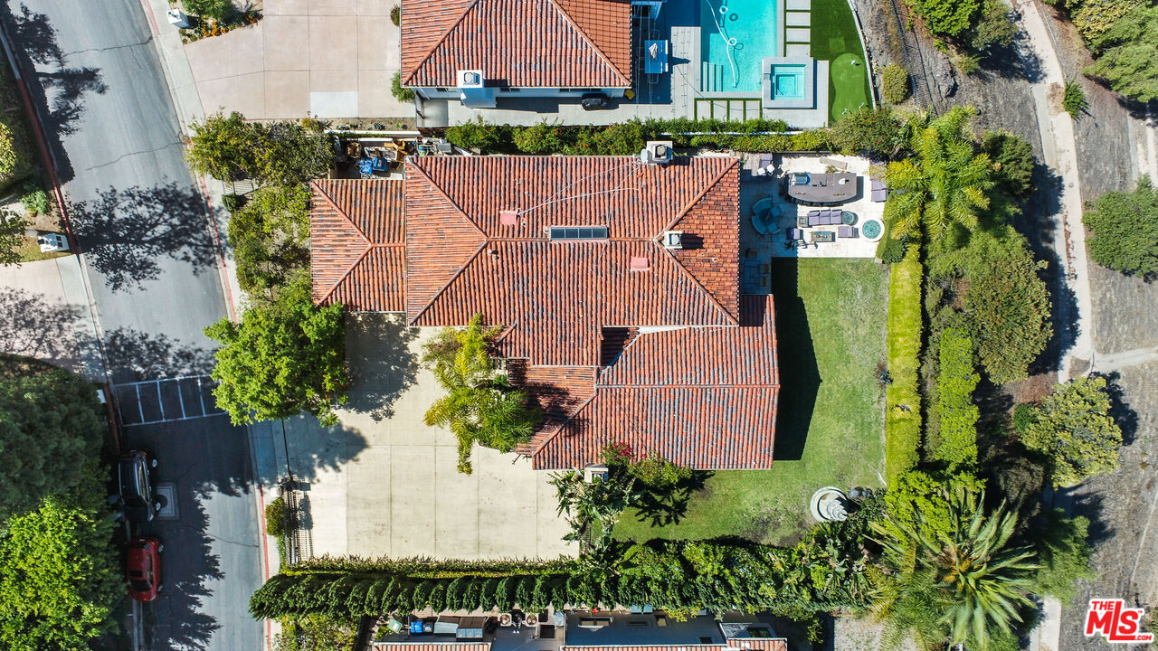 12535 Promontory Road Los Angeles, CA 90049 - Photo 35 of 42 an aerial view of a house with a garden and swimming pool