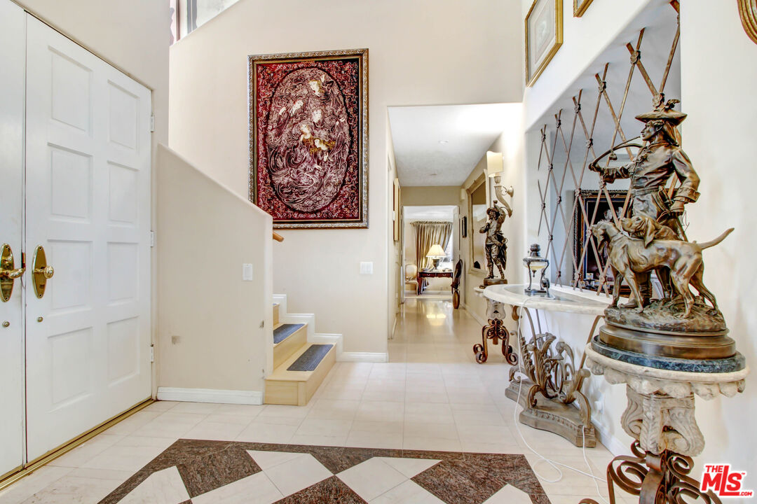 12535 Promontory Road Los Angeles, CA 90049 - Photo 5 of 42 a view of hall way with furniture and staircase