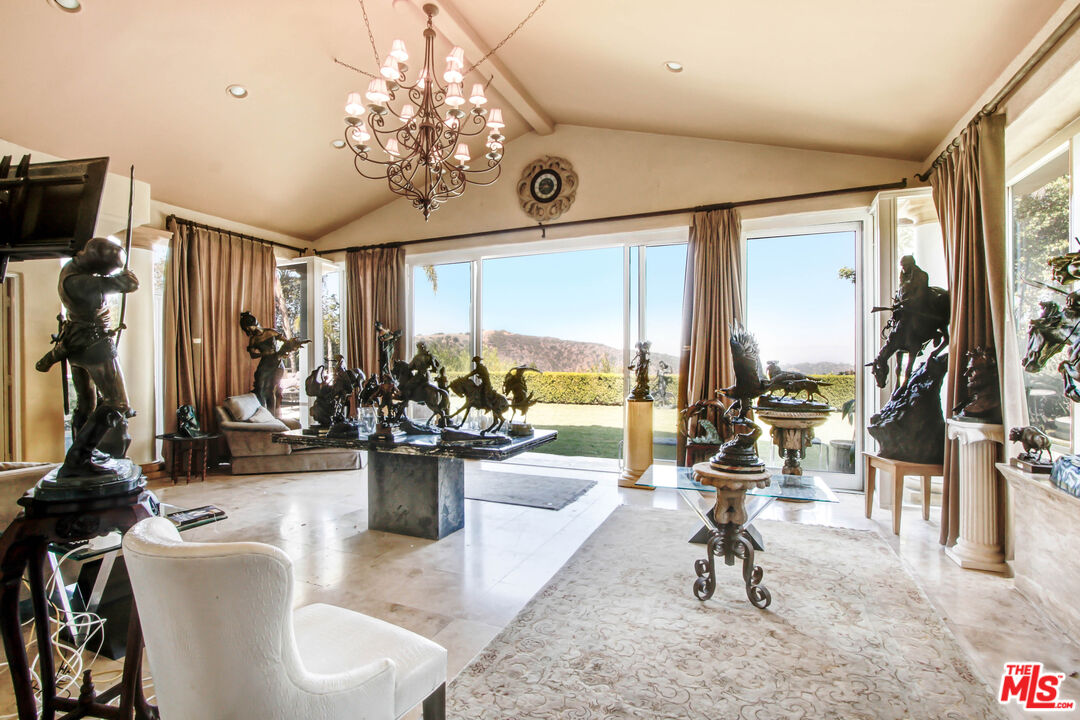 12535 Promontory Road Los Angeles, CA 90049 - Photo 9 of 42 a view of a livingroom with furniture and a ceiling fan