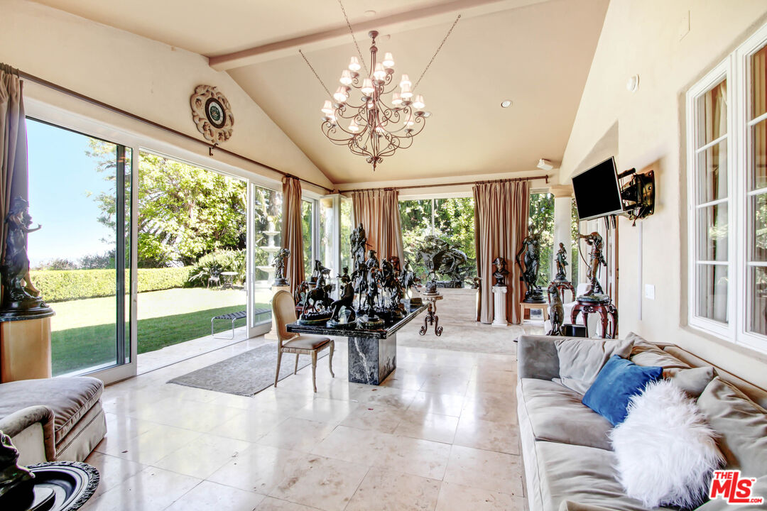 12535 Promontory Road Los Angeles, CA 90049 - Photo 10 of 42 a view of a dining room with furniture water view and a large window