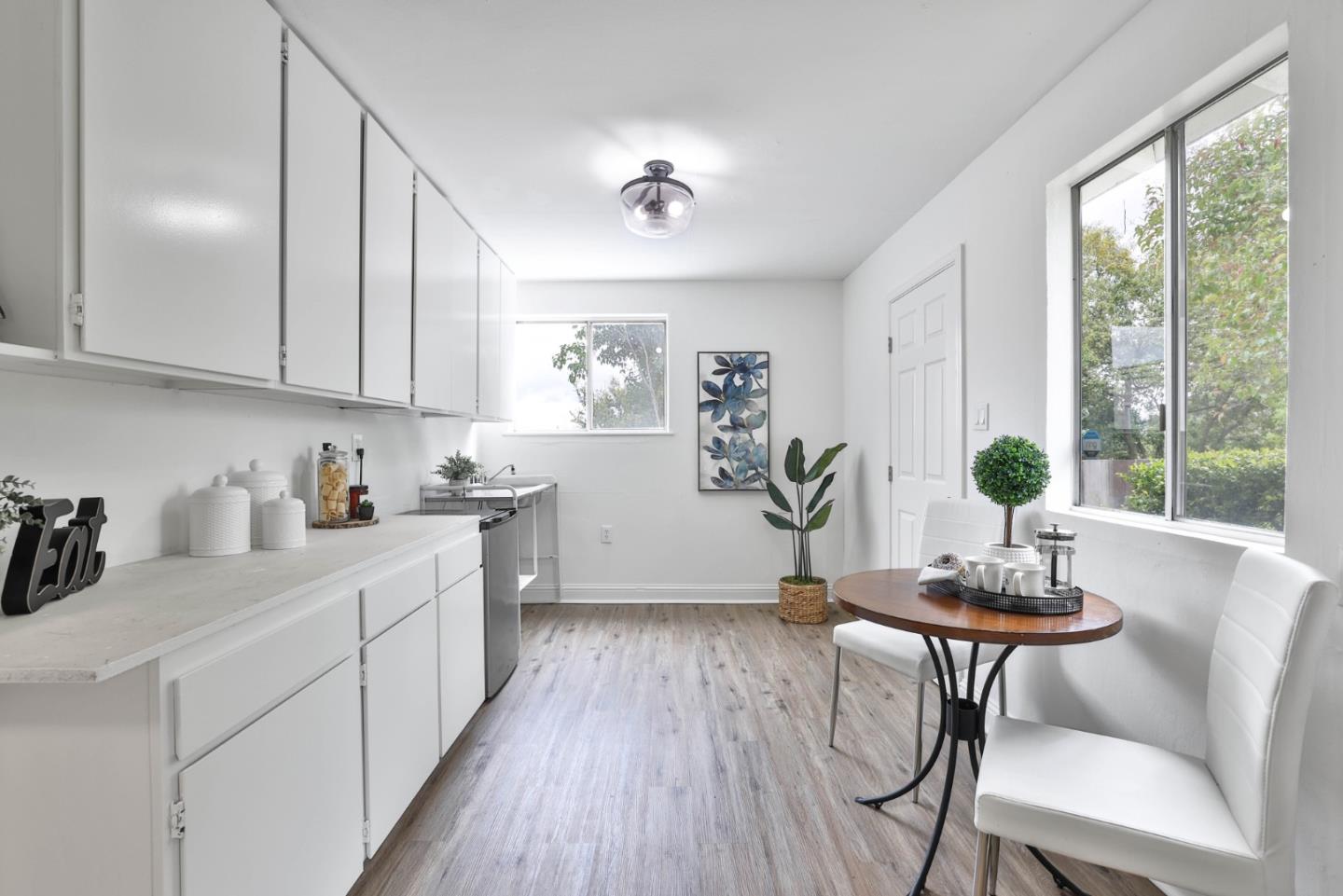 10036 Carmen Road Cupertino, CA 95014 - Photo 7 of 17 a kitchen with a dining table chairs and cabinets