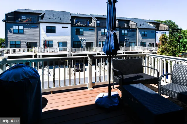 a view of a house with wooden deck