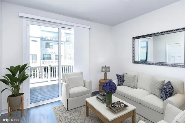 a living room with furniture and a window with garden view