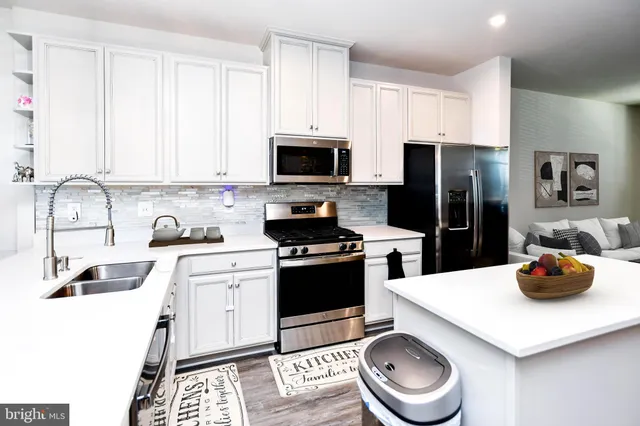 a kitchen with a sink stove and refrigerator