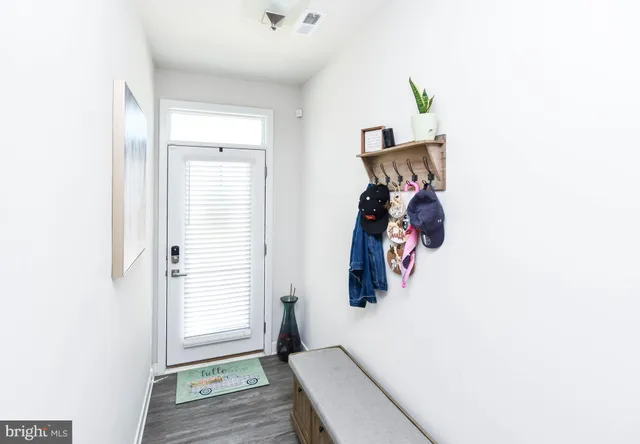 a view of a room with window and wooden floor