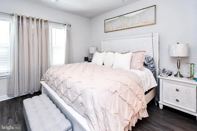 a bedroom with bed and wooden floor