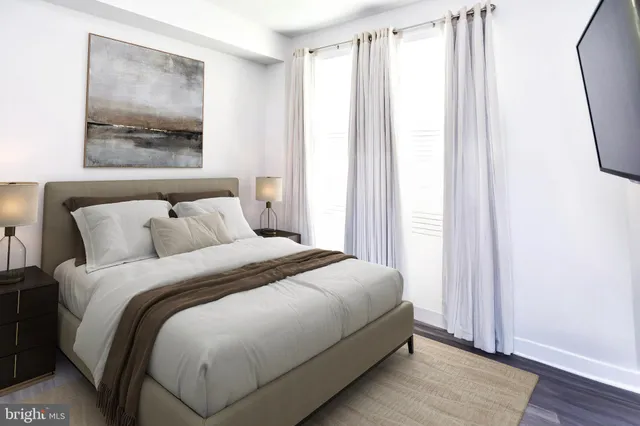 a bedroom with bed and a window