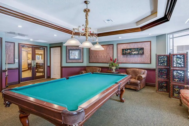 a room with pool table windows and windows