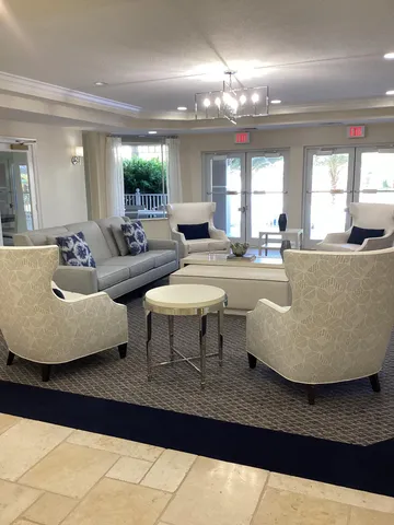 a living room with couches and painting on the wall