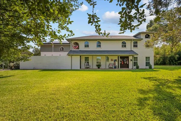 a view of a big yard with table and chairs under an umbrella