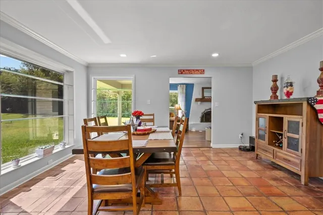 a dining room with furniture and window
