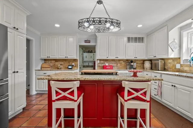 a kitchen with stainless steel appliances granite countertop a stove a sink dishwasher a microwave oven and a refrigerator with wooden cabinets