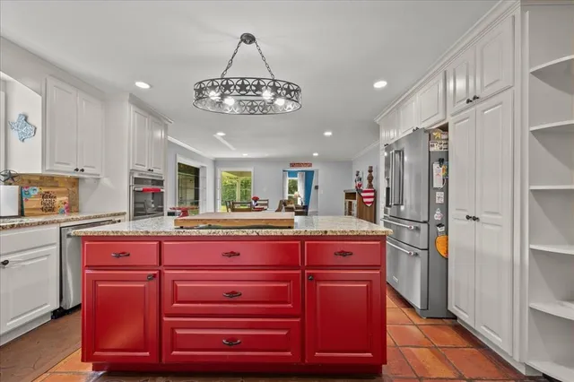 a kitchen with stainless steel appliances granite countertop a sink and cabinets