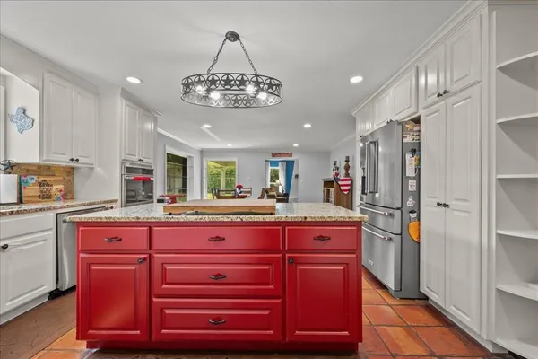 a kitchen with stainless steel appliances granite countertop a sink and cabinets