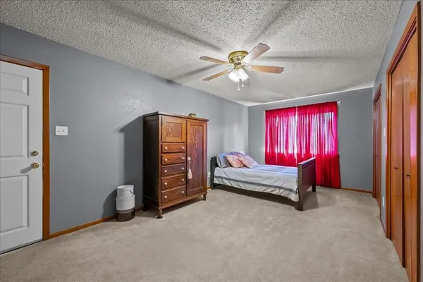 a bedroom with furniture and a ceiling fan