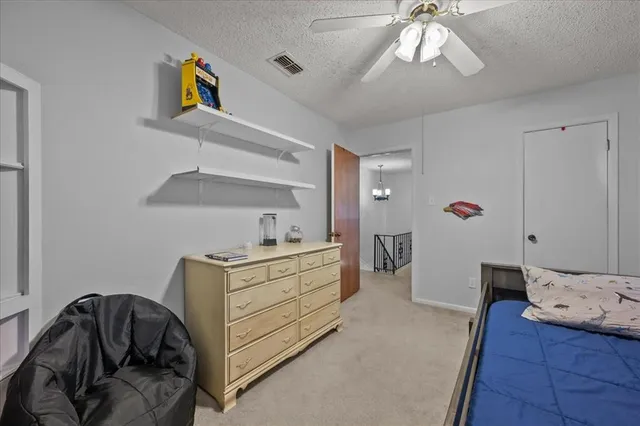 a bedroom with a bed and cabinets