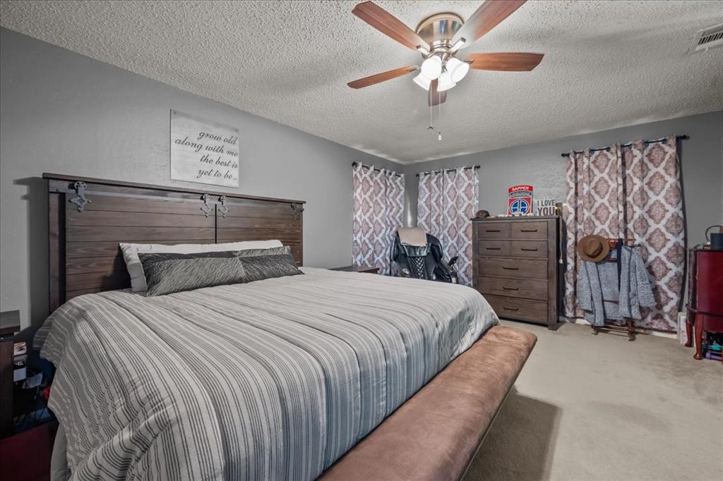 3400 Obrien Circle Waco, TX 76708 - Photo 27 of 36 a bedroom with a bed and a chandelier