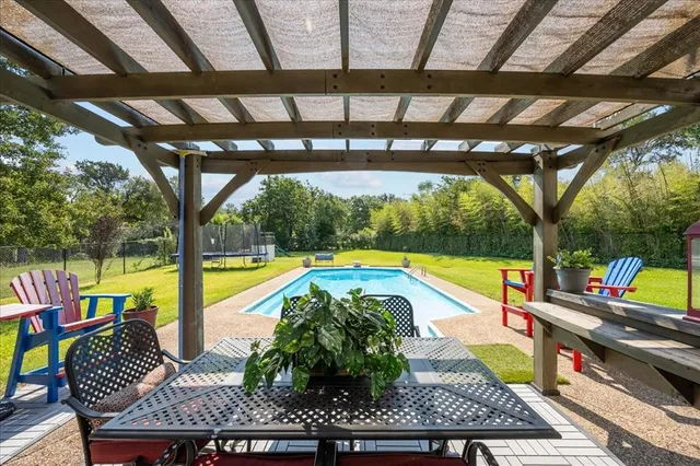 a view of swimming pool with sitting area