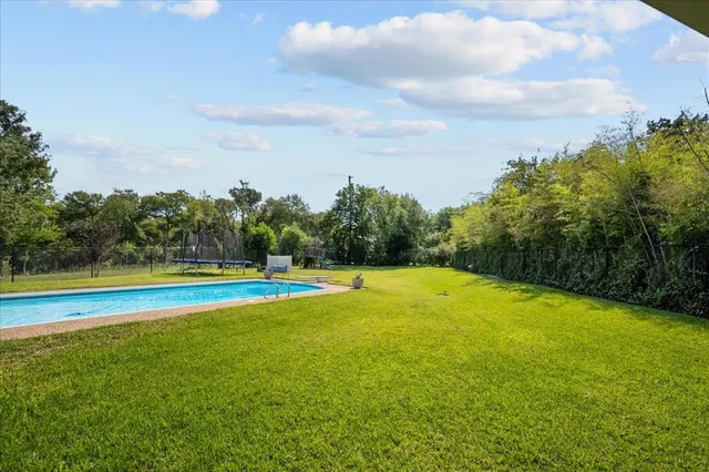 a view of a swimming pool with an outdoor space and seating area