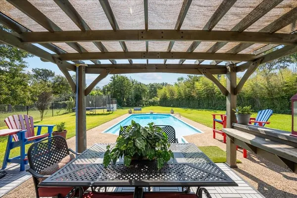 a view of swimming pool with sitting area