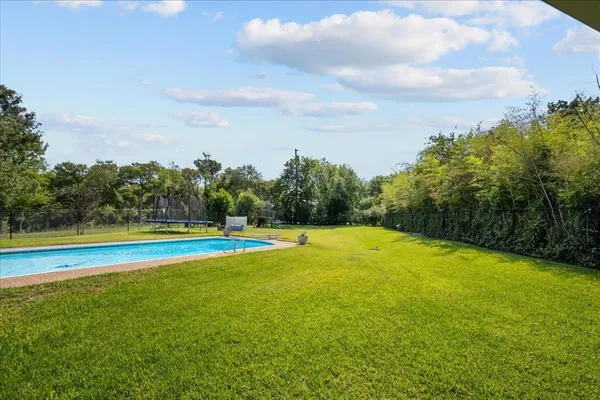 a view of a swimming pool with an outdoor space and seating area
