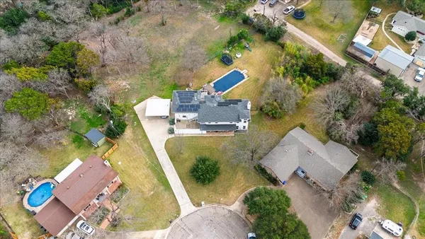 an aerial view of a house with outdoor space