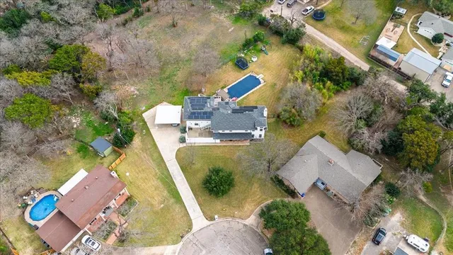 an aerial view of a house with outdoor space