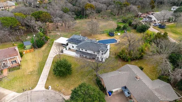 an aerial view of a house with a garden and swimming pool