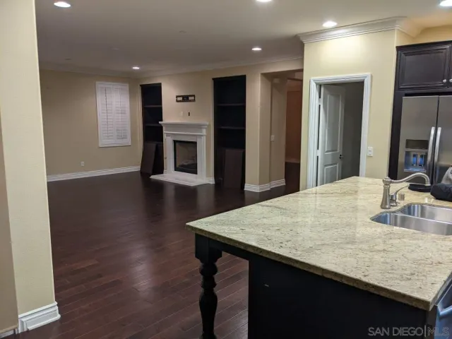 a kitchen with kitchen island a sink appliances and a counter top space