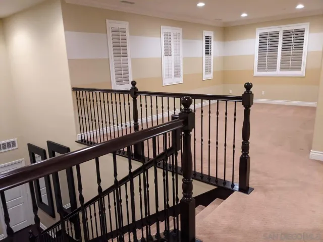 a view of staircase with windows